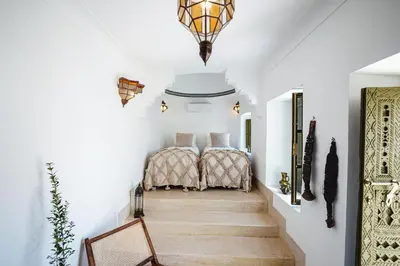 two beds in a hallway with white walls at Nahla Wellness in Marrakech