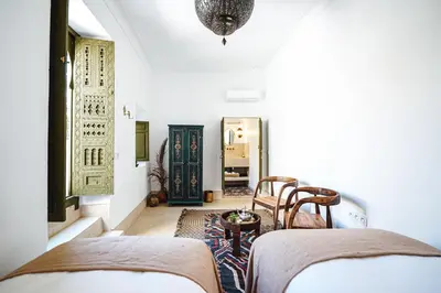 a bedroom with two beds and a hallway at Nahla Wellness in Marrakech