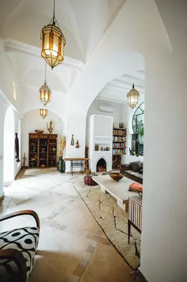 a living room with a table and a fireplace at Nahla Wellness in Marrakech