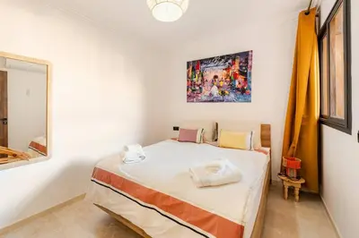 a bedroom with a bed in a white room at Berber Atlas Marrakech with Pool in Marrakech