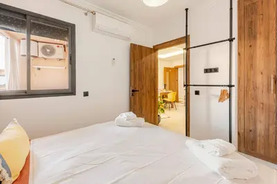 a bedroom with a white bed and a sliding glass door at Berber Atlas Marrakech with Pool in Marrakech