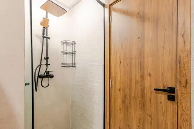a shower with a glass door next to a shower at Berber Atlas Marrakech with Pool in Marrakech