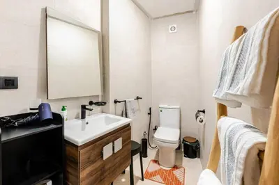 a bathroom with a sink and a toilet and a mirror at Berber Atlas Marrakech with Pool in Marrakech