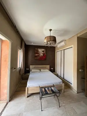 a bedroom with a large bed and a chandelier at nice apartment and good location in Marrakech