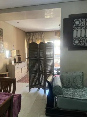 a living room with a couch and a kitchen at nice apartment and good location in Marrakech