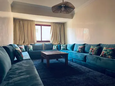 a living room with a blue couch and a table at Bright Place and High Quality Mattress in Marrakech