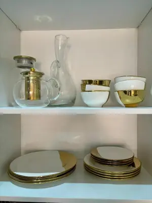 a shelf with plates and bowls and a vase at Cocoon in Gueliz, Netflix, IPTV in Marrakech