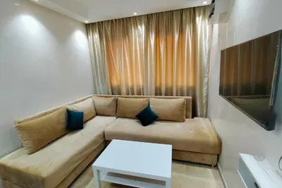 a living room with a couch and a table at Cozy Apt in Heart of Marrakech, Walk Everywhere in Marrakech
