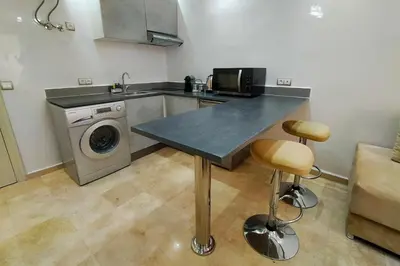 a kitchen with a counter top and a washing machine at Cozy Apt in Heart of Marrakech, Walk Everywhere in Marrakech