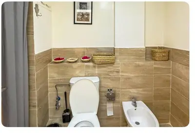 a bathroom with a toilet and a sink at Cozy apartment with a pool2 in Marrakech