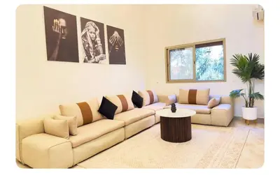 a living room with a couch and a table at Cozy apartment with a pool2 in Marrakech