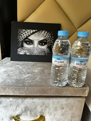 two bottles of water sitting on top of a table at Cozy apartment with a pool2 in Marrakech