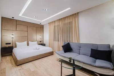 a bedroom with a bed and a couch at Cozy Appartement in the heart of Gueliz Marrakech in Marrakech