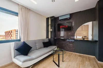 a living room with a couch and a tv at Cozy Appartement in the heart of Gueliz Marrakech in Marrakech