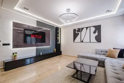 a living room with a couch and a tv at Cozy Appartement in the heart of Gueliz Marrakech in Marrakech