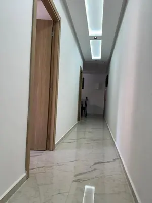 an empty hallway with a door and a tile floor at Aube Hivernage appartement in Marrakech