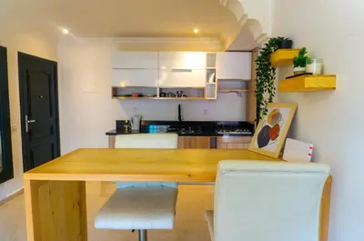 a kitchen with a wooden table in a room at Appartement Walili in Marrakech