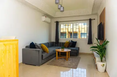 a living room with a couch and a table at Appartement Walili in Marrakech