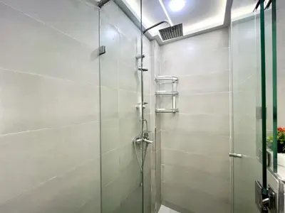 a shower with a glass door in a bathroom at Appartement Chic et Confortable, Netflix, PS4 & Wi-Fi Centre Marrakech in Marrakech