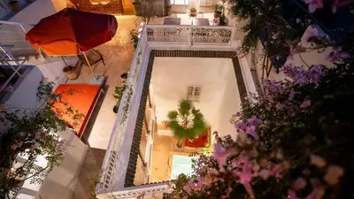 an overhead view of a pool in a building with flowers at Riad Dar Zioui in Marrakech