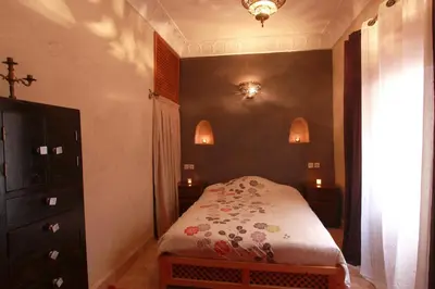 a small bedroom with a bed and a dresser at Riad Khalid Zrika Marrakech in Marrakech