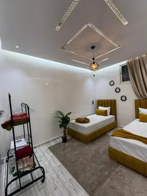 a bedroom with two beds and a ladder in it at Housna B&B Marrakesh in Marrakech