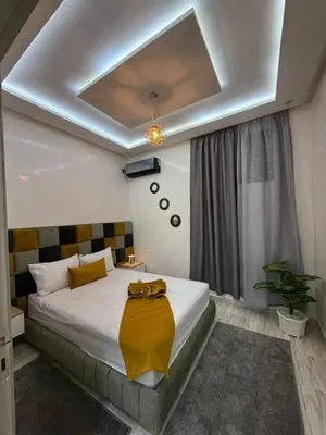a bedroom with a bed with a yellow blanket on it at Housna B&B Marrakesh in Marrakech