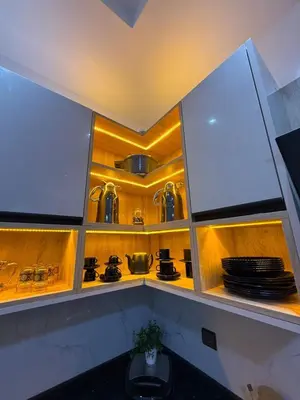 a kitchen with wooden shelves with pots and pans at Housna B&B Marrakesh in Marrakech
