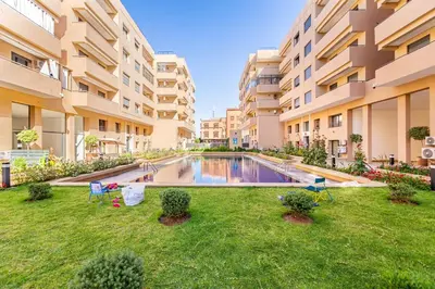 an image of an apartment yard with a swimming pool at Appartement Haut de Gamme avec Piscine Privée et Grande Terrasse in Marrakech