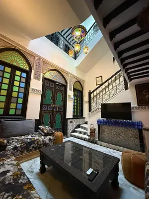 a living room with a couch and a coffee table at RIAD SAAD Marrakech in Marrakech