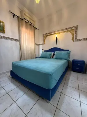a bedroom with a blue bed in a room at RIAD SAAD Marrakech in Marrakech
