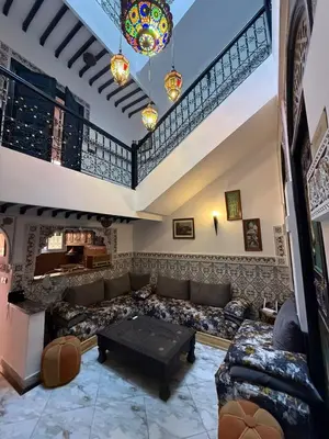 a large living room with a couch and a table at RIAD SAAD Marrakech in Marrakech