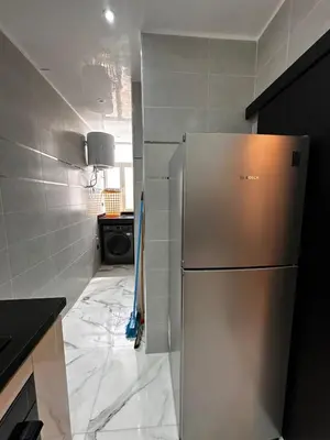 a kitchen with a stainless steel refrigerator in a room at Appartement Familial Spacieux & Moderne - Confort et Style au Rendez-vous ! in Marrakech