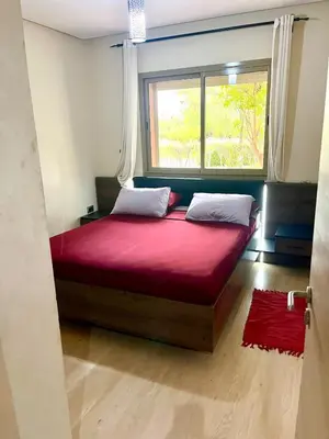 a bedroom with a large bed with a window at Cozy RC golf view pool & Atlas fiber optic 2 bedrooms in Marrakech