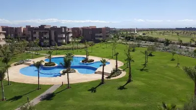 an aerial view of a park with a swimming pool at Cozy RC golf view pool & Atlas fiber optic 2 bedrooms in Marrakech