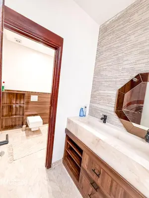 a bathroom with a sink and a mirror at Villa 5 chambres targa in Marrakech