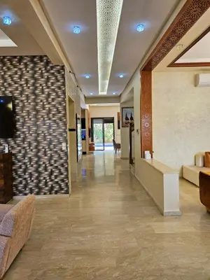 a hallway of a hospital with a couch and a tv at Villa in Marrakech in Marrakech