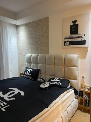 a bedroom with a bed with black and white pillows at Chanel home in Marrakech