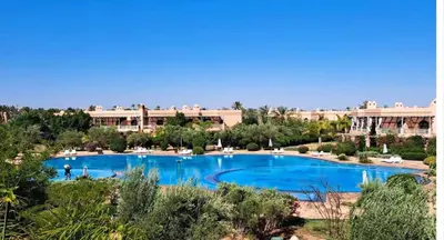 a large swimming pool in front of a resort at la palmeraie village 3 in Marrakech