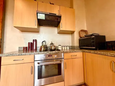 a kitchen with a stainless steel oven and microwave at la palmeraie village 3 in Marrakech