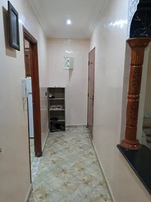 a hallway with a room with a refrigerator and a door at Sweet home in Marrakech