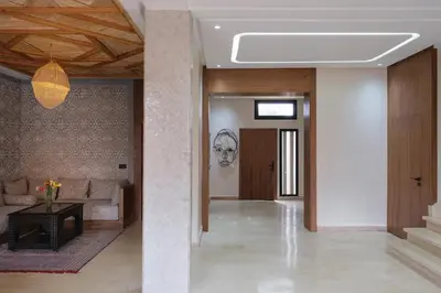 a living room with a couch and a table at Riad Beldi Chic Golf Al Maaden in Marrakech