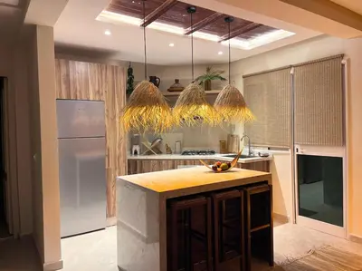 a kitchen with a island in the middle of it at Appartement Luxueux à Guéliz in Marrakech