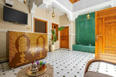 a bathroom with a tub and a tv and a table at Riad Ryme-Newly renovated-Exclusive-Free breakfast in Marrakech