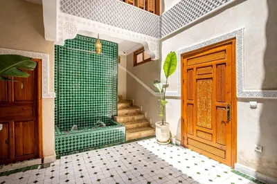 a bathroom with a shower and a door and a plant at Riad Ryme-Newly renovated-Exclusive-Free breakfast in Marrakech