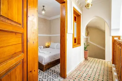 a bedroom with a bed and a hallway with a door at Riad Ryme-Newly renovated-Exclusive-Free breakfast in Marrakech