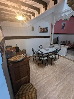 a dining room with a table and chairs in a room at riad rabiaa in Marrakech
