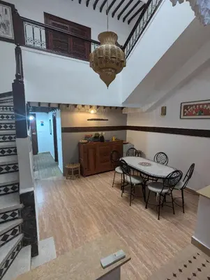a dining room with a table and chairs at riad rabiaa in Marrakech