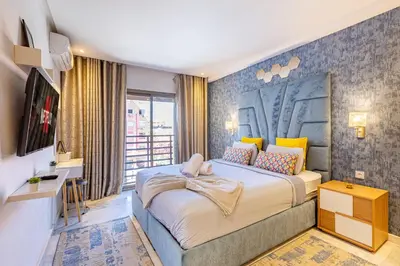 a bedroom with a large bed and a desk at AkHouse PB15 Fully Equipped - Guéliz TOP Center in Marrakech