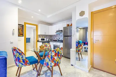 a kitchen and dining room with a glass table and chairs at AkHouse PB15 Fully Equipped - Guéliz TOP Center in Marrakech
